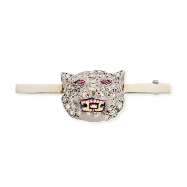 A DIAMOND, RUBY AND ENAMEL WOLF BROOCH designed as the head of a wolf pave set with round