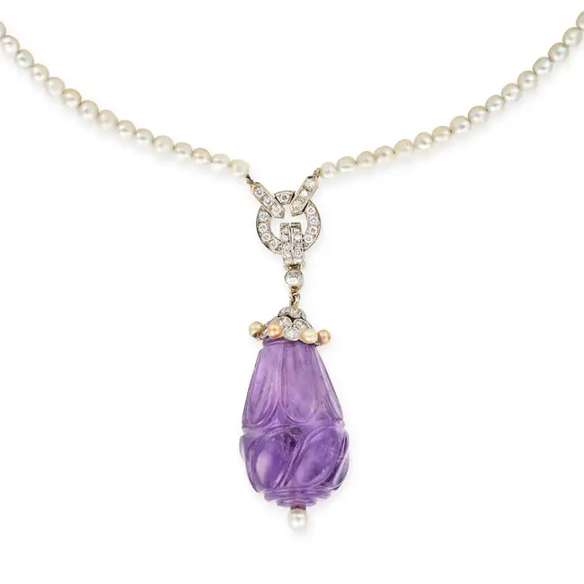 A FINE VINTAGE AMETHYST, DIAMOND AND PEARL PENDANT NECKLACE the pendant comprising a large carved