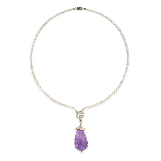 A FINE VINTAGE AMETHYST, DIAMOND AND PEARL PENDANT NECKLACE the pendant comprising a large carved
