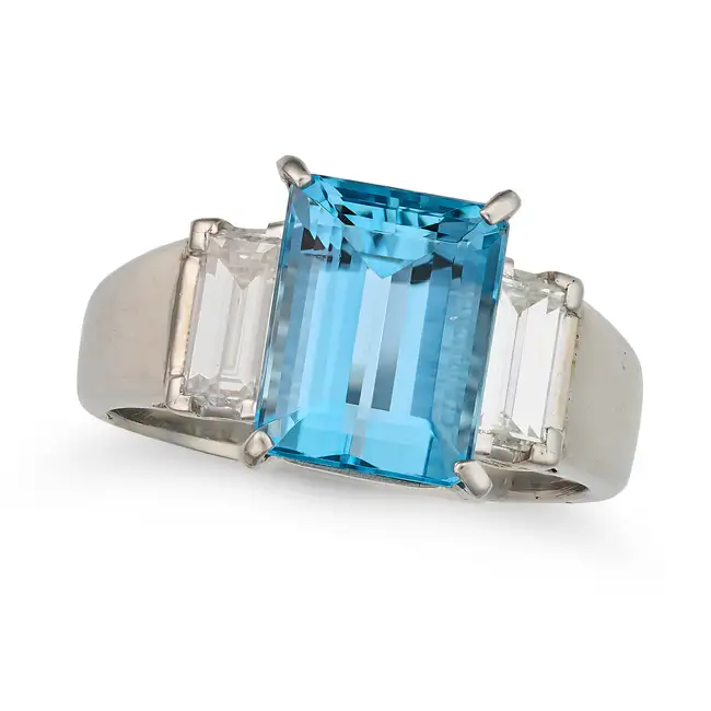 AN AQUAMARINE AND DIAMOND THREE STONE RING set with an octagonal step cut aquamarine of 3.72 carats,