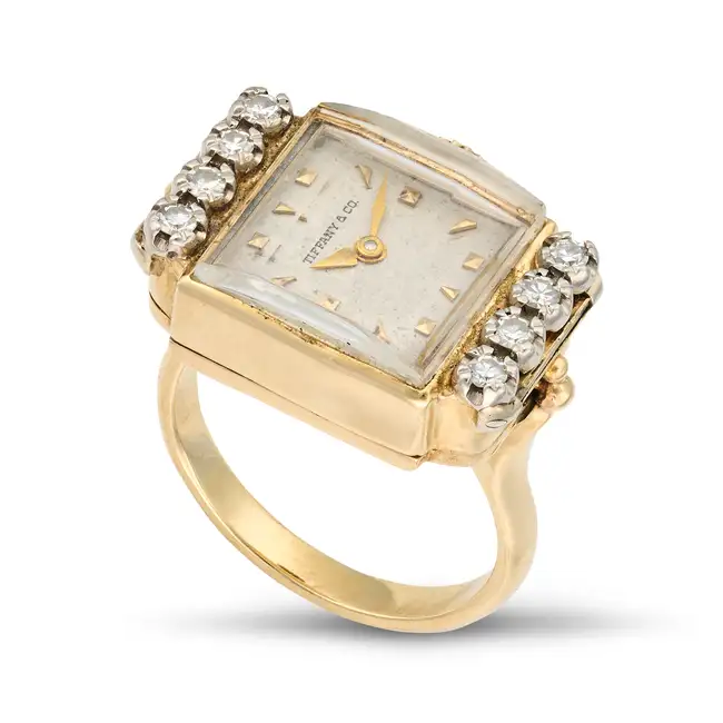A DIAMOND WATCH RING the rectangular dial signed Tiffany & Co. with baton hour markers, set to the
