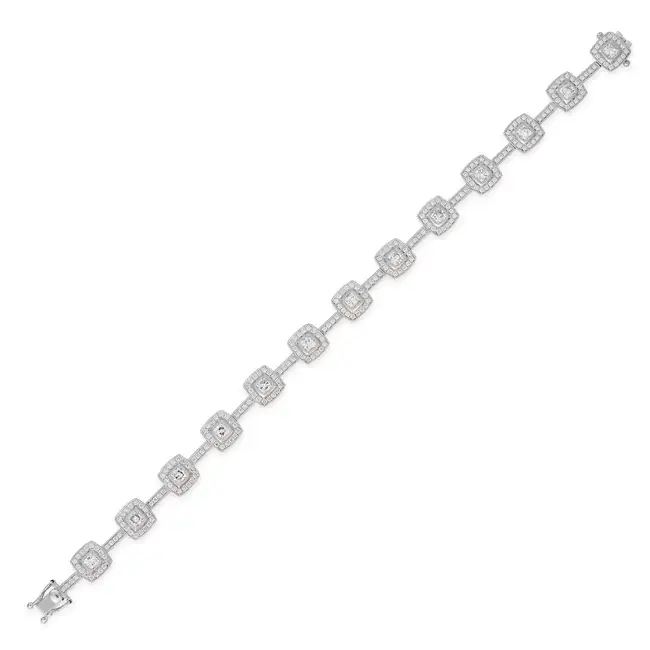 A DIAMOND BRACELET comprising a row of links set with cushion cut diamonds in borders of round