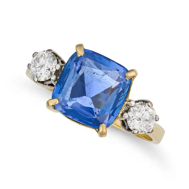 A 6.03 CARAT BURMA NO HEAT SAPPHIRE AND DIAMOND RING in 18ct yellow gold, set with a cushion cut