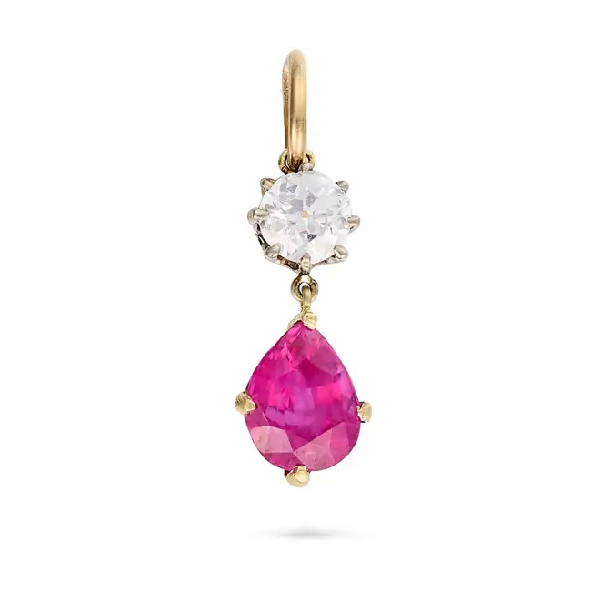 A RUBY AND DIAMOND PENDANT set with an old cut diamond of approximately 0.25 carats and a pear cut