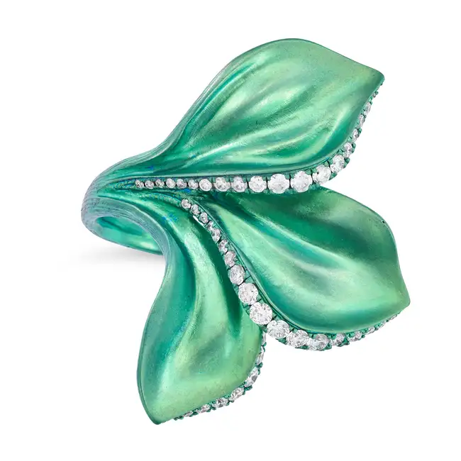 ALEXIS NY, A TITANIUM AND DIAMOND FLOWER RING designed as a flower accented by rows of round