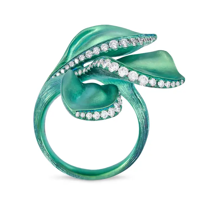 ALEXIS NY, A TITANIUM AND DIAMOND FLOWER RING designed as a flower accented by rows of round