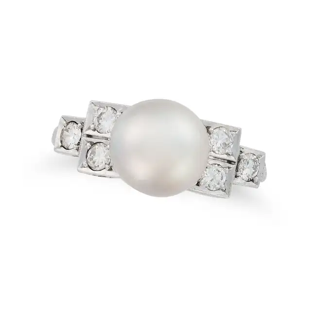 A PEARL AND DIAMOND DRESS RING set with a pearl of 9.4mm, the stepped shoulders set with round