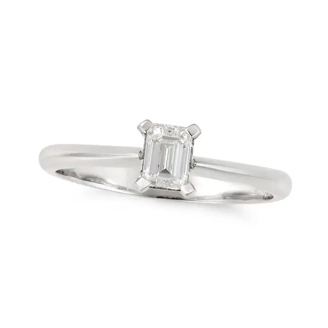 A SOLITAIRE DIAMOND RING in platinum, set with an emerald cut diamond of 0.41 carats, full British