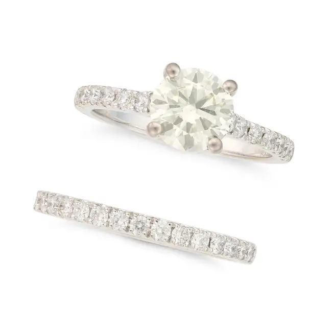 A DIAMOND ENGAGEMENT RING AND WEDDING BAND the engagement ring set with a round brilliant cut