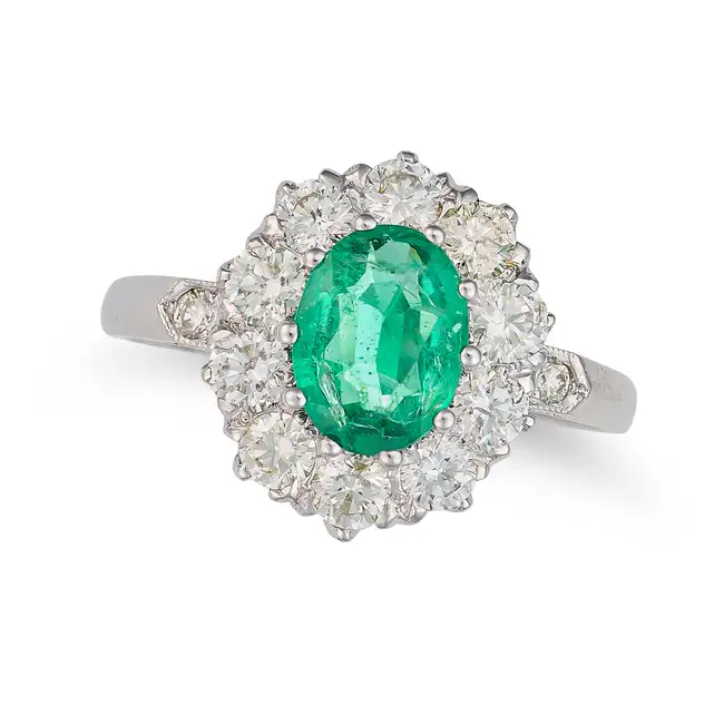 AN EMERALD AND DIAMOND CLUSTER RING set with an oval cut emerald of approximately 1.00 carat in a