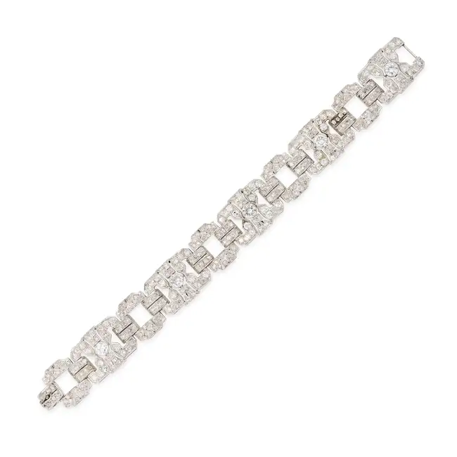 A FINE ART DECO DIAMOND STRAP BRACELET comprising a row of pierced geometric links, set throughout