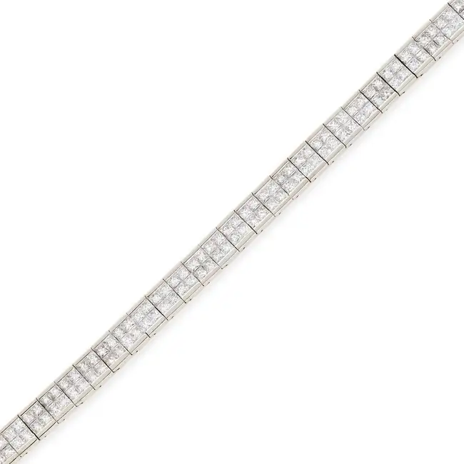 A DIAMOND BRACELET in 18ct white gold, comprising two rows of princess cut diamonds totalling 6.5-