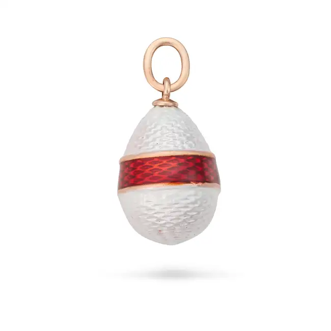 A RUSSIAN ENAMEL EGG PENDANT the egg shaped pendant relieved in white enamel, accented by red enamel