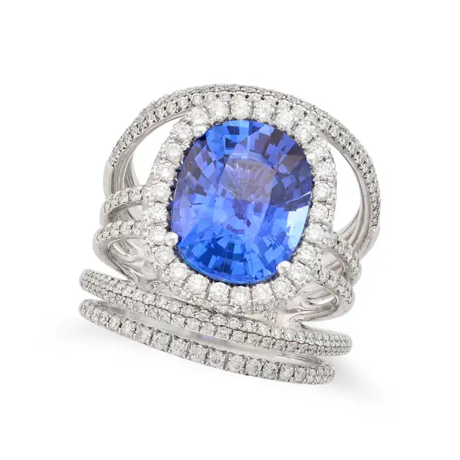 A SAPPHIRE AND DIAMOND DRESS RING set with a cushion cut sapphire of approximately 6.28 carats