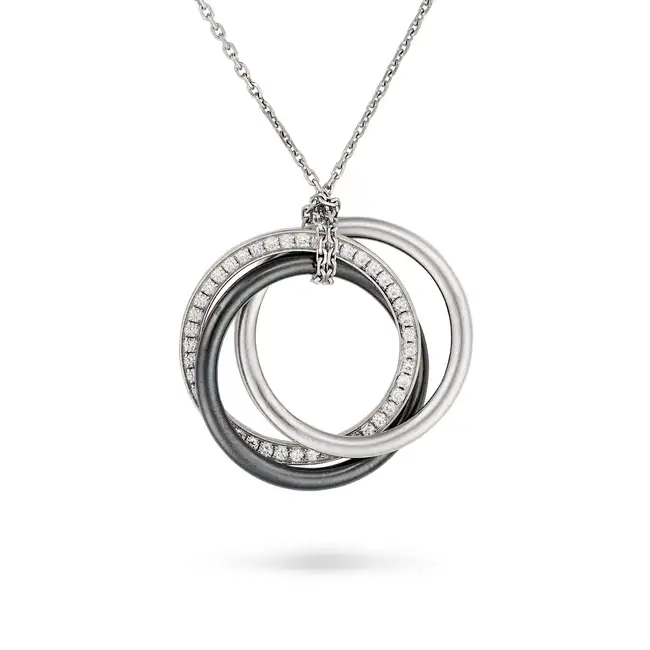 CARTIER, A CERAMIC AND DIAMOND TRINITY NECKLACE in 18ct white gold, the pendant designed as three