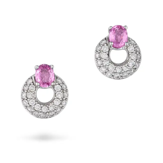 A PAIR OF PINK SAPPHIRE AND DIAMOND EARRINGS in 18ct white gold, each set with an oval cut pink