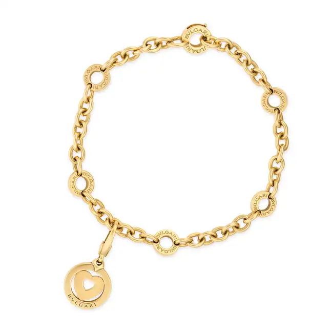 BULGARI, A BVLGARI BVLGARI CHARM BRACELET in 18ct yellow gold, comprising a trace chain punctuated