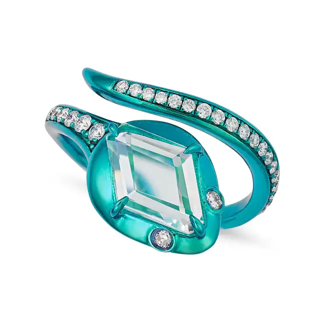 ALEXIS NY, A TITANIUM, WHITE SAPPHIRE AND DIAMOND SNAKE RING designed as a coiled snake, the head