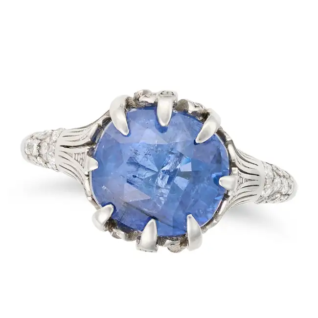 A SAPPHIRE AND DIAMOND RING set with a cushion cut sapphire of approximately 5.26 carats, the