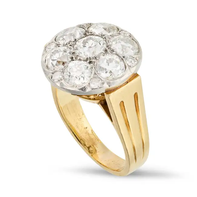 A VINTAGE DIAMOND CLUSTER RING set with a cluster of old cut diamonds, accented by single cut