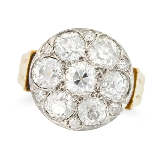 A VINTAGE DIAMOND CLUSTER RING set with a cluster of old cut diamonds, accented by single cut