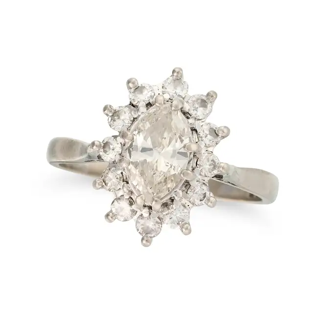 A DIAMOND CLUSTER RING in 18ct white gold, set with a marquise cut diamond of approximately 0.75