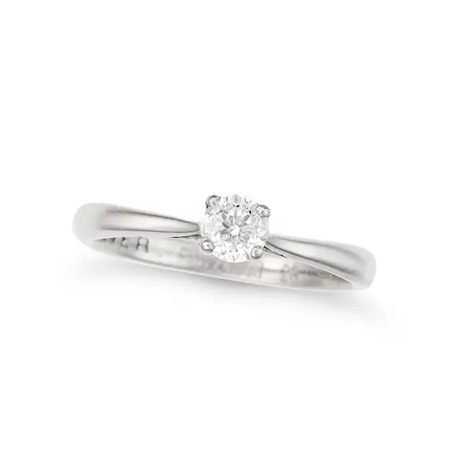 A SOLITAIRE DIAMOND RING in palladium, set with a round brilliant cut diamond of 0.28 carats,
