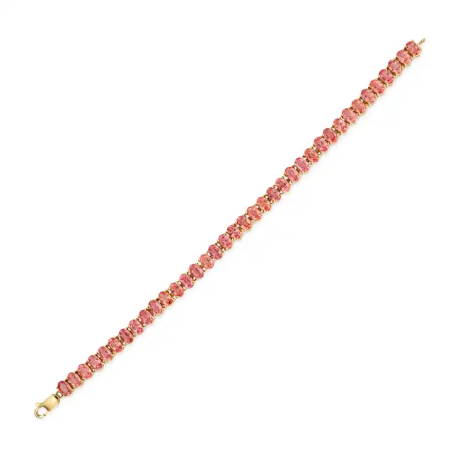 A PEACH SAPPHIRE LINE BRACELET comprising a row of oval cut peach sapphires totalling 17.5-18.0