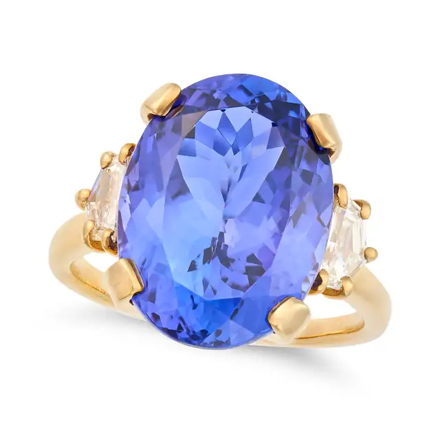 A FINE TANZANITE AND DIAMOND DRESS RING in 18ct yellow gold, set with an oval cut tanzanite of