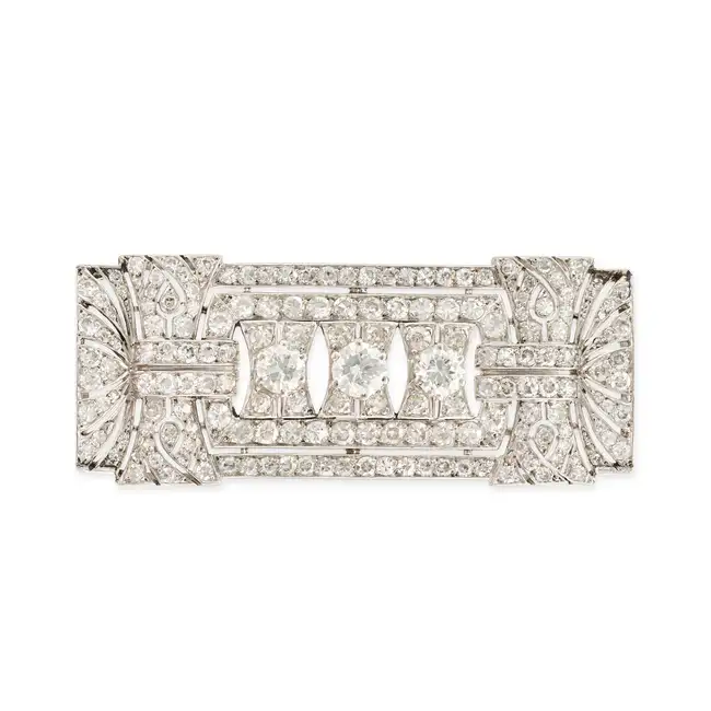AN ART DECO FRENCH DIAMOND PLAQUE BROOCH in platinum, the rectangular openwork brooch set with three