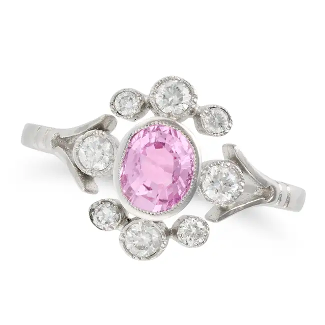 NO RESERVE - A PINK SAPPHIRE AND DIAMOND RING in platinum, set with an oval cut pink sapphire of