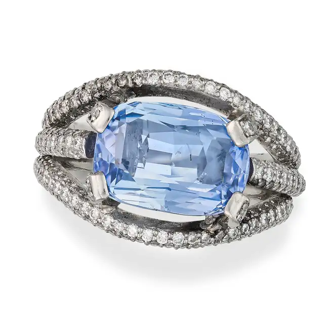 A 7.12 CARAT CEYLON NO HEAT SAPPHIRE AND DIAMOND RING set with a cushion cut sapphire of 7.12