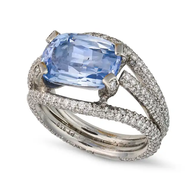 A 7.12 CARAT CEYLON NO HEAT SAPPHIRE AND DIAMOND RING set with a cushion cut sapphire of 7.12