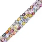 A MULTICOLOUR SAPPHIRE AND DIAMOND STRAP BRACELET set with variously cut blue, pink, yellow,