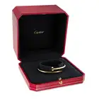 CARTIER, A CLASSIC MODEL JUSTE UN CLOU BANGLE in 18ct yellow gold, designed as bent nail, signed