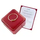 CARTIER, A CLASSIC MODEL JUSTE UN CLOU BANGLE in 18ct yellow gold, designed as bent nail, signed