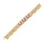 BOUCHERON, A VINTAGE RUBY AND DIAMOND BRACELET in 18ct yellow gold, comprising a row of modular