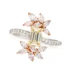 A YELLOW AND PINK DIAMOND RING set with an emerald cut yellow diamond, accented by sprays of