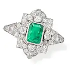 AN EMERALD AND DIAMOND DRESS RING, EARLY 20TH CENTURY set with an octagonal step cut emerald of