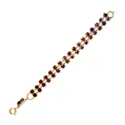NO RESERVE - AN ANTIQUE GARNET BRACELET comprising two rows of cushion cut garnets, two garnets