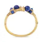 AN ANTIQUE ETRUSCAN REVIVAL LAPIS LAZULI BANGLE in yellow gold, the hinged bangle in crossover