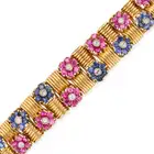A VINTAGE RUBY, SAPPHIRE AND DIAMOND BRACELET in 18ct yellow gold, comprising fluted links, accented