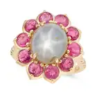 A STAR SAPPHIRE, RUBY AND DIAMOND CLUSTER RING set with an oval cabochon star sapphire of 8.30