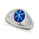 A SYNTHETIC STAR SAPPHIRE AND DIAMOND RING set with a cabochon star sapphire of approximately 3.10