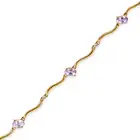NO RESERVE - AN AMETHYST AND WHITE SAPPHIRE BRACELET in 9ct yellow gold, comprising a row of