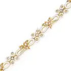 AN ANTIQUE DIAMOND, AQUAMARINE AND ENAMEL BRACELET comprising a row of scrolling links and links