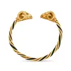 A VINTAGE ENAMEL RAM BANGLE in 18ct yellow gold, the open cuff bangle in twisted design, relieved in