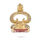 AN ANTIQUE CARNELIAN FOB SEAL / PENDANT the scrolling foliate style pendant set with a carnelian