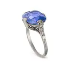 AN ART DECO CEYLON NO HEAT SAPPHIRE AND DIAMOND RING set with a cushion cut sapphire of 6.52 carats,