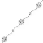 A DIAMOND BRACELET comprising clusters of round brilliant cut diamonds and round brilliant cut